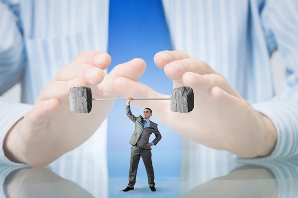 Businessman covered with palms — Stock Photo, Image