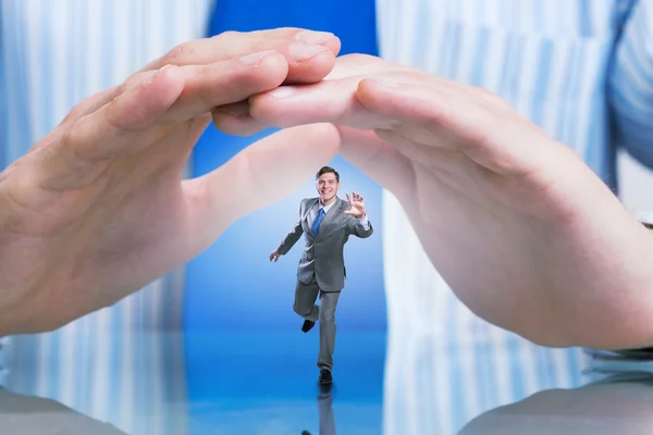 Businessman covered with palms — Stock Photo, Image