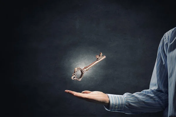 Key symbol in hand — Stock Photo, Image