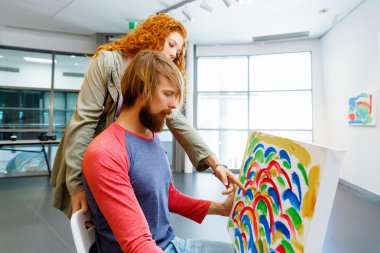 Genç çift ayakta bir galeride ve sanat da geçiş