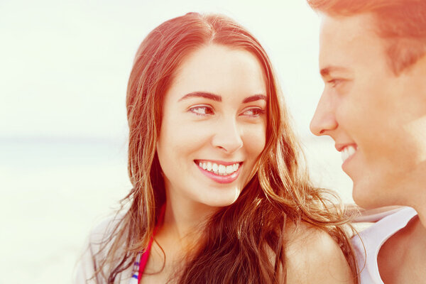 Romantic young couple sitting on the beach