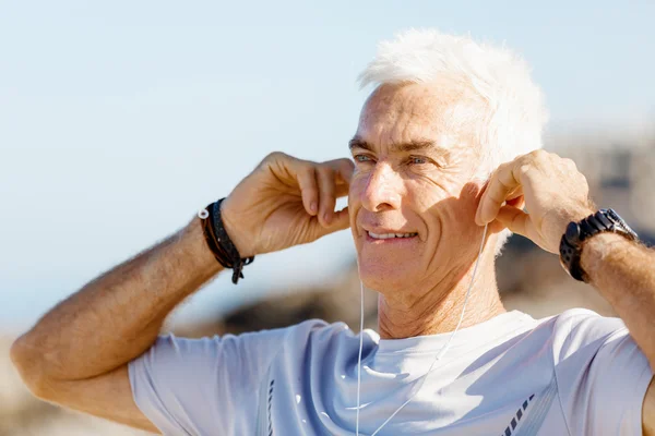 Sport och musik. man sig redo för jogging — Stockfoto