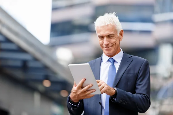 Senior businessman holding touchpad — Stock Photo, Image