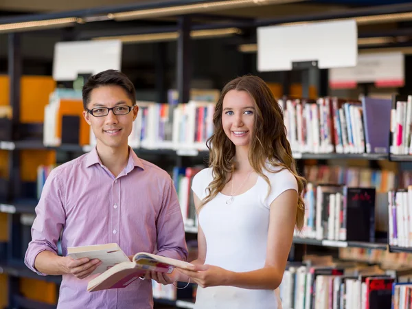 Dois jovens estudantes na biblioteca — Fotografia de Stock