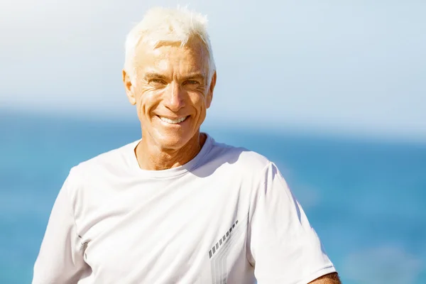 Man standing on beach in sports wear Stock Image