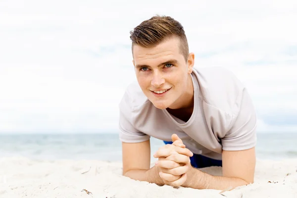 Man training on beach outside Stock Picture