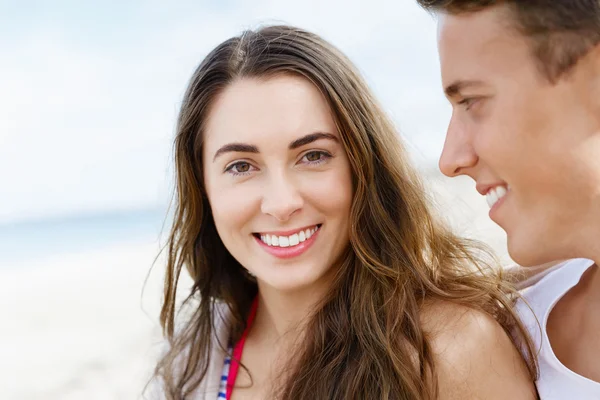 Romantic young couple sitting on the beach Stock Image