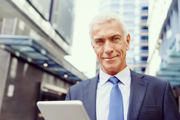 Senior businessman holding touchpad — Stock Photo, Image