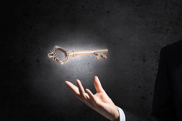 Key symbol in hand — Stock Photo, Image