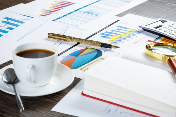 Financial charts and graphs on the table — Stock Photo, Image