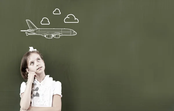 Thoughtful girl standing at blackboard — Stock Photo, Image