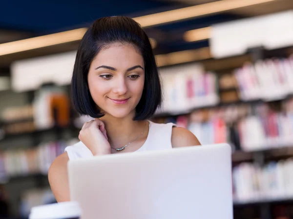 Happy female student at the library — Stock Photo, Image