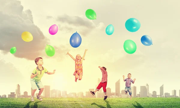 Enfants ludiques attraper des ballons — Photo