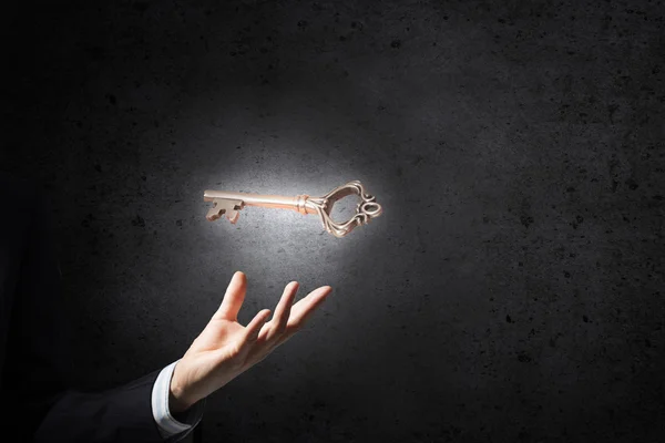 Key symbol in hand — Stock Photo, Image