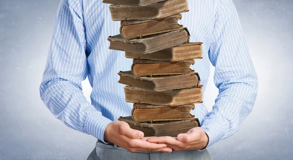 Man with worn books — Stock Photo, Image