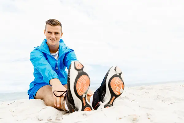 Man training on beach outside Stock Image