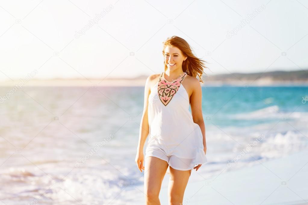 Young woman walking along the beach