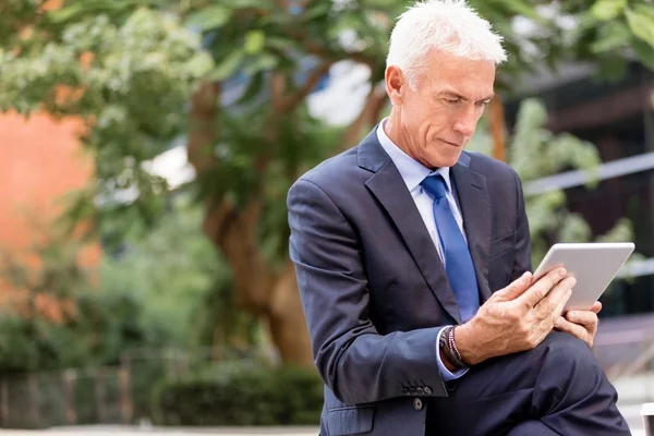 Senior businessman holding touchpad — Stock Photo, Image