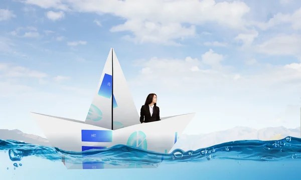 Businesswoman in boat made of paper — Stock Photo, Image