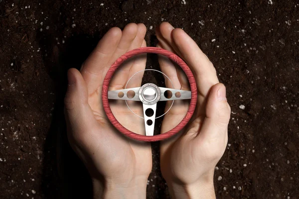 Car steering wheel in palms — Stock Photo, Image