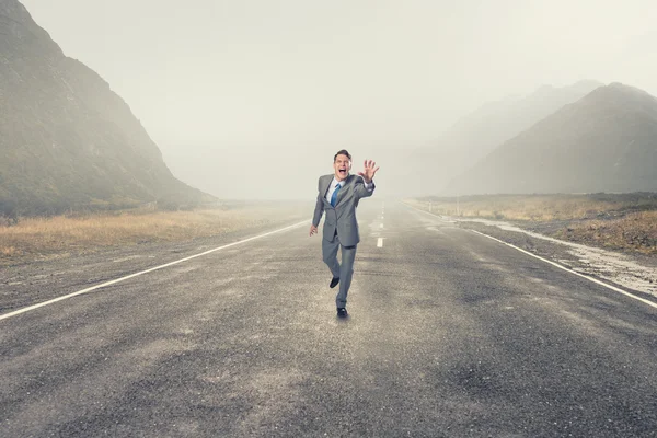 Man running and reaching hand — Stock Photo, Image