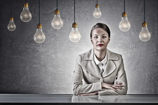 Attractive businesswoman sitting at table — Stock Photo, Image