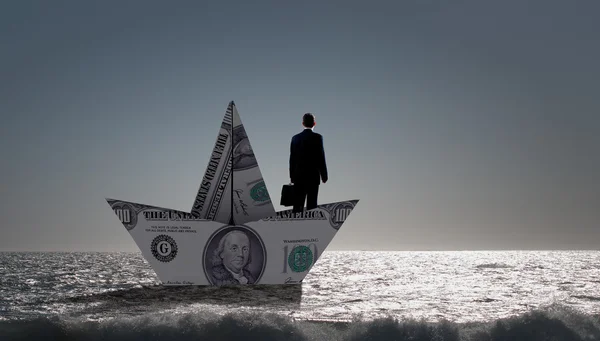 Businessman in boat made of dollar banknote — Stock Photo, Image
