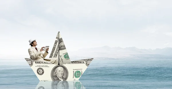 Businessman in boat made of dollar banknote — Stock Photo, Image