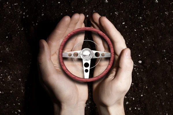 Car steering wheel in palms — Stock Photo, Image