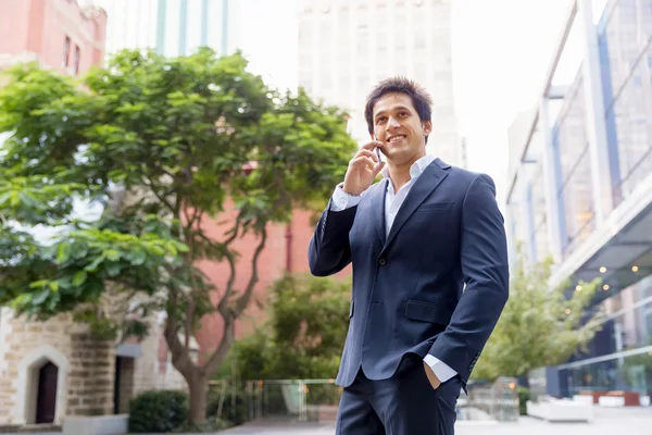 Portrait of confident businessman with mobile phone outdoors — Stock Photo, Image