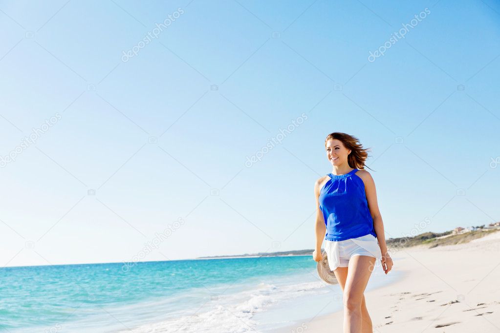 Young woman walking along the beach