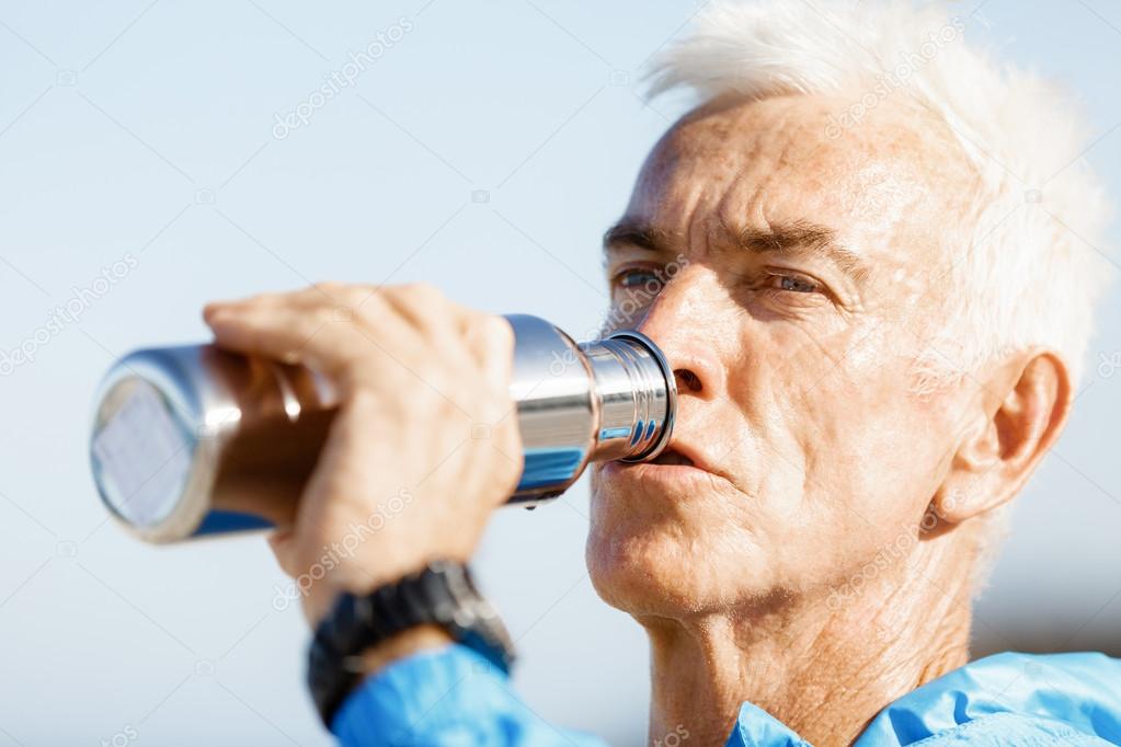 Man drinking from a sports bottle