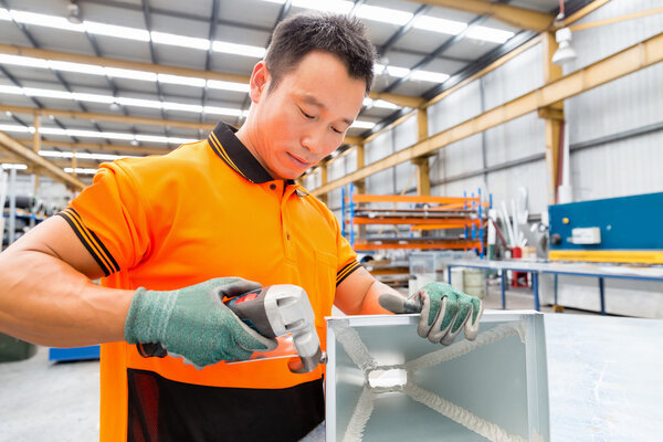 Asian worker in production plant on the factory floor