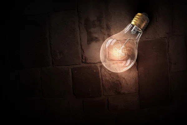 Light bulb op baksteen oppervlak — Stockfoto