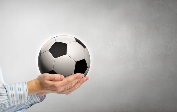 Soccer ball in hands — Stock Photo, Image