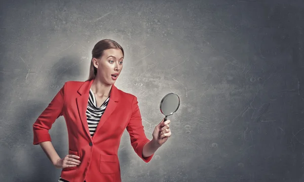 Girl using magnifier for search — Stock Photo, Image