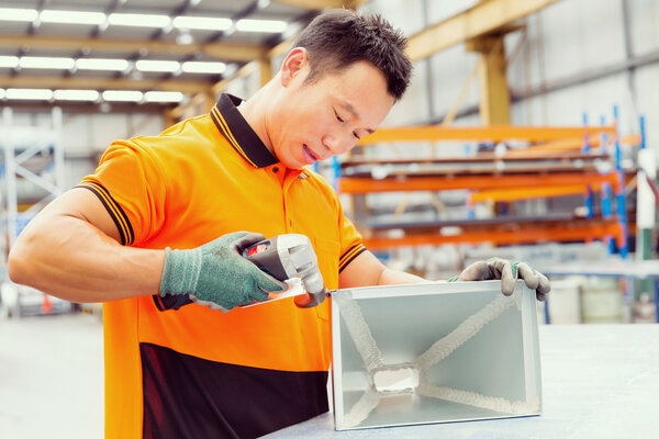 Asian worker in production plant on the factory floor