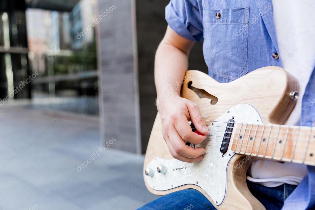 Hands of musician with guitar