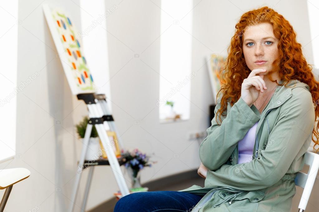 Young caucasian woman in art gallery front of  paintings