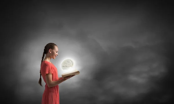 Girl holding opened book — Stock Photo, Image