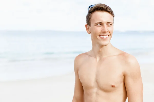 Knappe man die zich voordeed op strand — Stockfoto