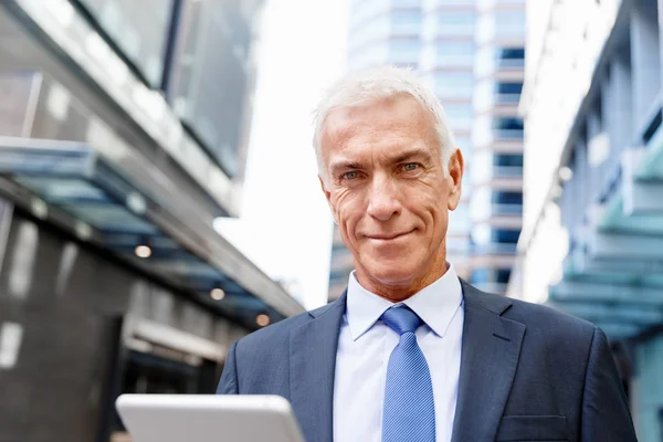 Senior businessman holding touchpad — Stock Photo, Image