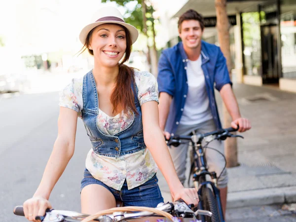 Happy couple in city with bike — Stock Photo, Image