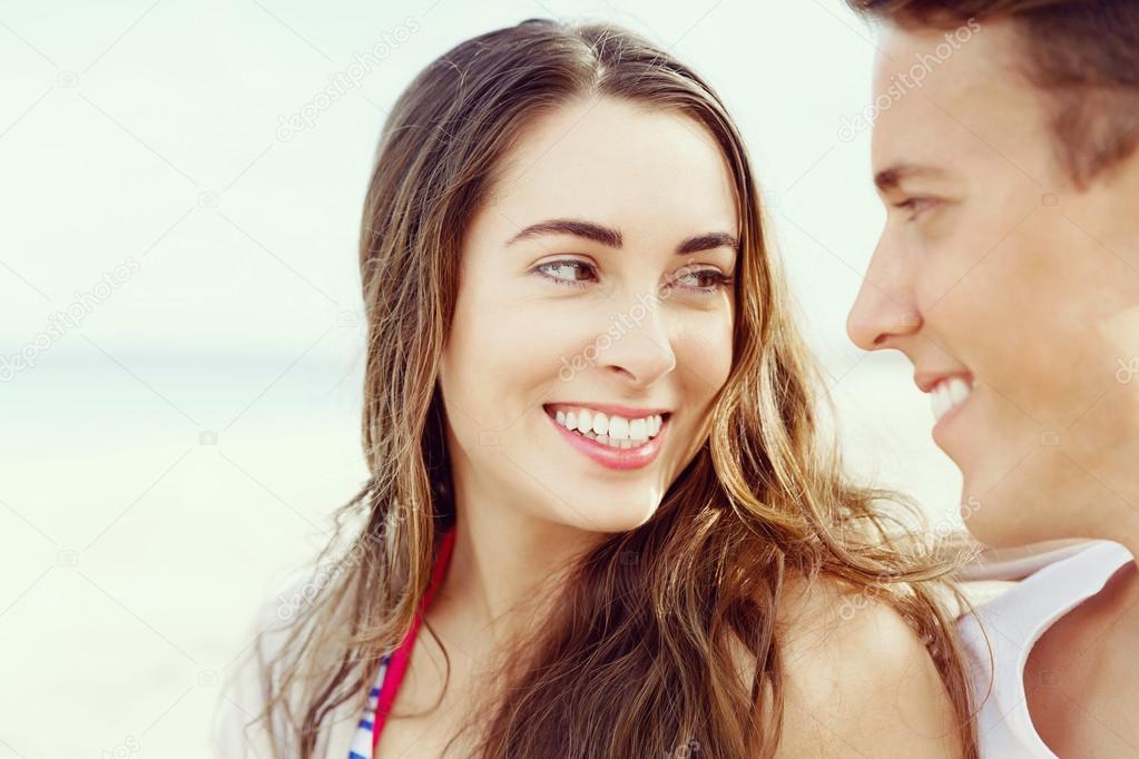 Romantic young couple sitting on the beach