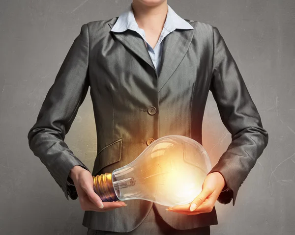 Electric bulb in woman hand — Stock Photo, Image