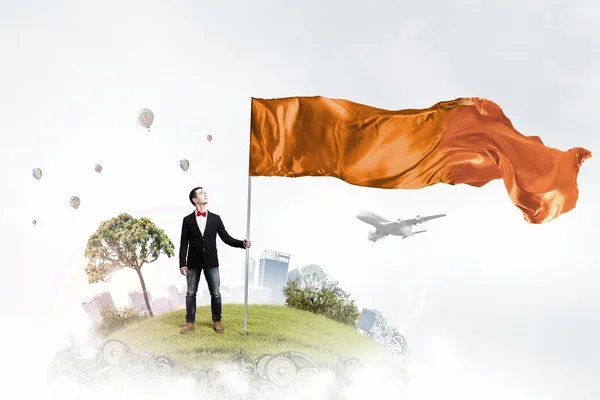 Man with orange waving flag — Stock Photo, Image