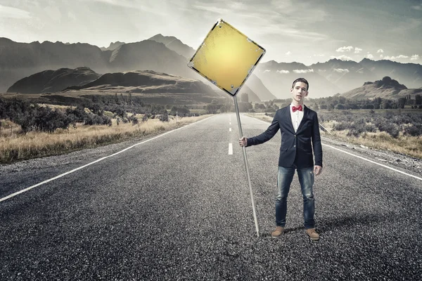 Guy showing roadsign — Stock Photo, Image