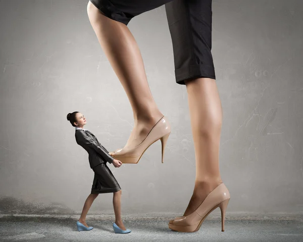 Big boss woman steping on colleague — Stock Photo, Image