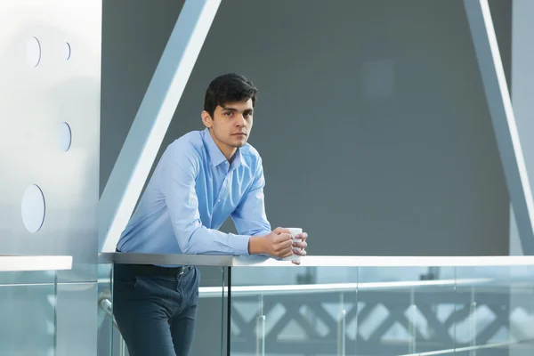 Businessman leaning on balcony railings — Stock Photo, Image