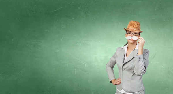 Businesswoman trying paper mustache — Stock Photo, Image